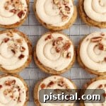 Cream Cheese Frosted Carrot Cookies 10 Carrot Cake Cookies lined up on a cooling rack, freshly baked and ready to be frosted.