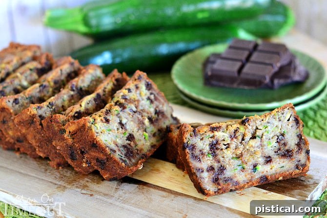 A slice of Chocolate Chip Zucchini Banana Bread taken out of the loaf, showing its moist texture and chocolate chips.