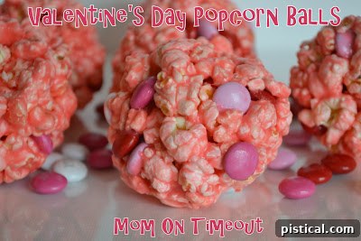 Sweetheart Popcorn Bites 10 Three vibrant Valentine's Day Popcorn Balls on a white surface.