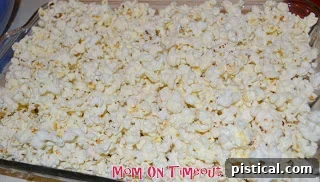 Sweetheart Popcorn Bites 4 Warm popped popcorn filling a baking dish.