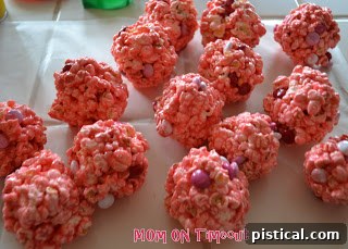 Sweetheart Popcorn Bites 9 Forming a festive Valentine's Day Popcorn Ball with M&Ms.