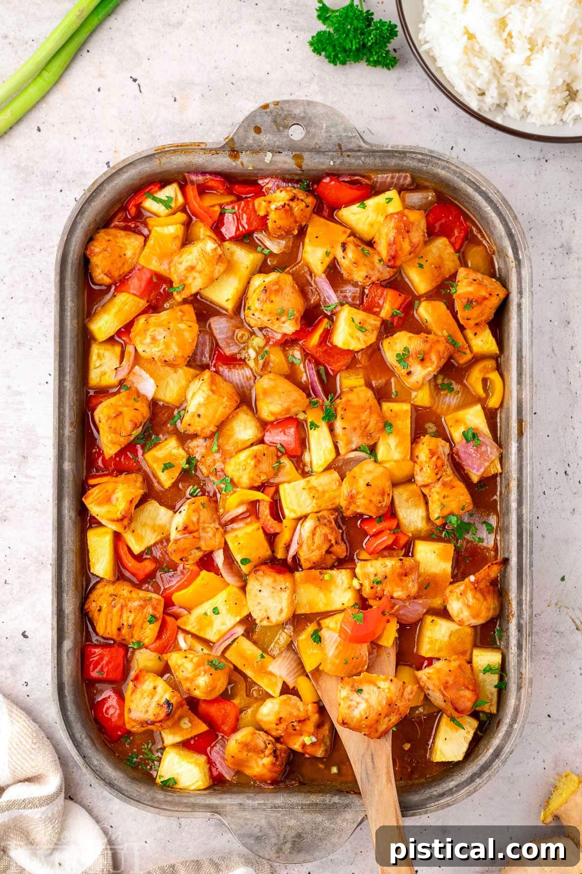 Pineapple Glazed Island Chicken 3 Overhead view of Hawaiian Chicken sheet pan recipe, freshly roasted and still in the sheet pan, ready to be served. Highlights the vibrant colors of chicken, pineapple, and bell peppers.