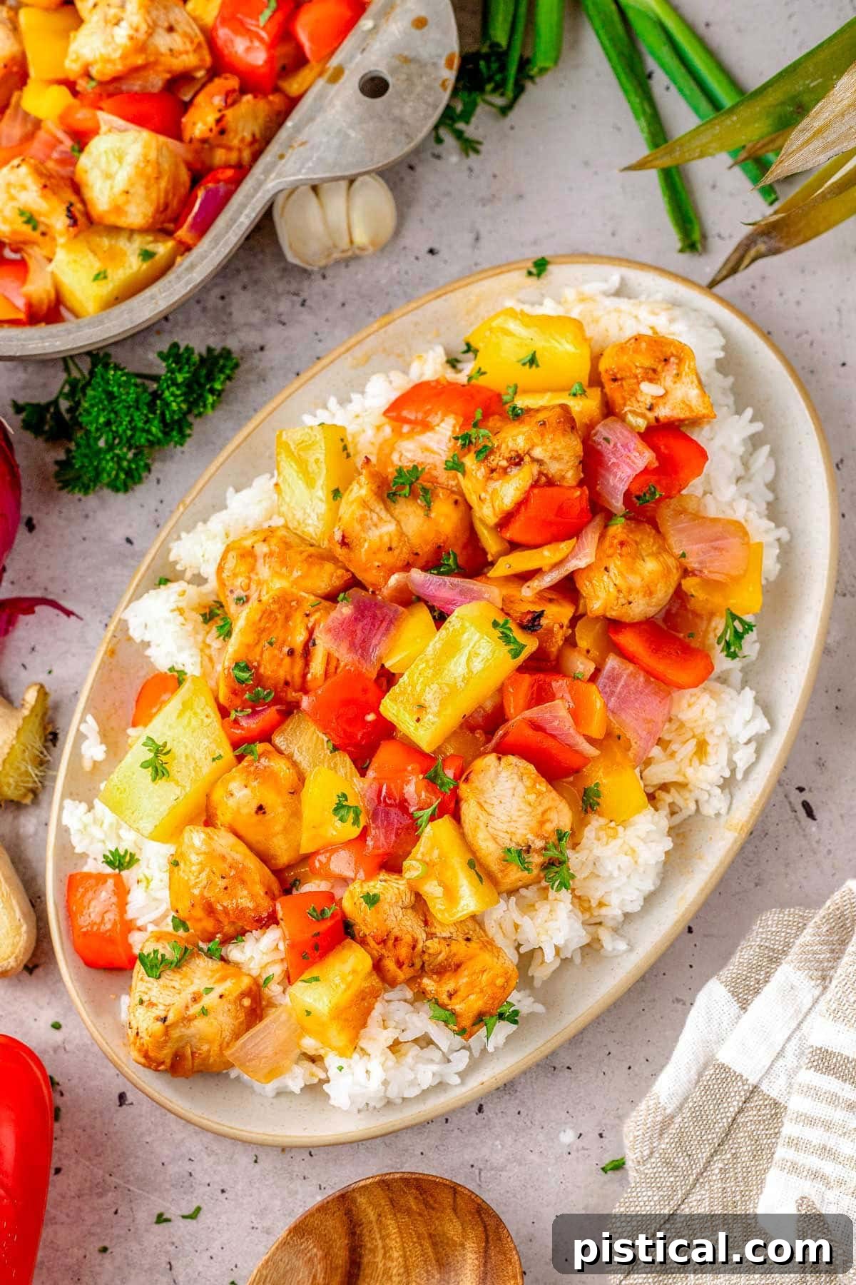 Pineapple Glazed Island Chicken 6 Hawaiian Chicken recipe plated with rice on an oval plate, garnished with green onions.