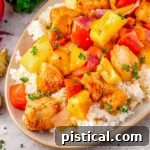 Close up look at Hawaiian Chicken recipe plated with rice on an oval plate.