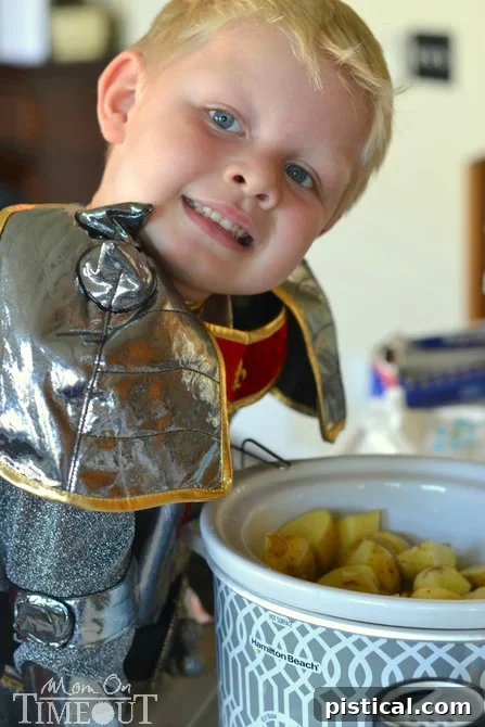 Bryce helping to prepare potatoes for the slow cooker