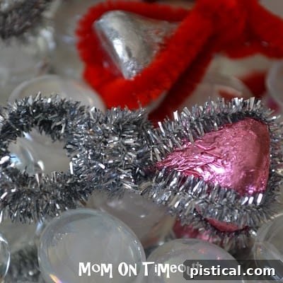 Another view of a child's hand with a red Hershey's Kiss ring, a 'ruby'.