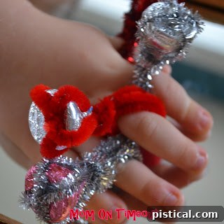 A child's hand showing off a Hershey's Kiss ring with visible delight.