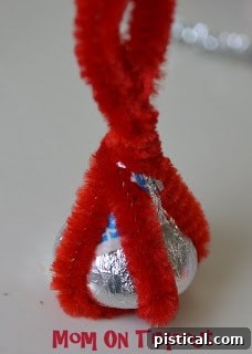 Pipe cleaners separated into two on each side, pulled away from the Hershey's Kiss.