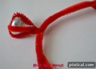 Pipe cleaner ends bent to form a circular ring shape around a finger.
