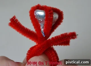 Ends of the pipe cleaners twisted around at the top of the ring band for a secure finish.