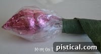 Floral tape being applied to the stem