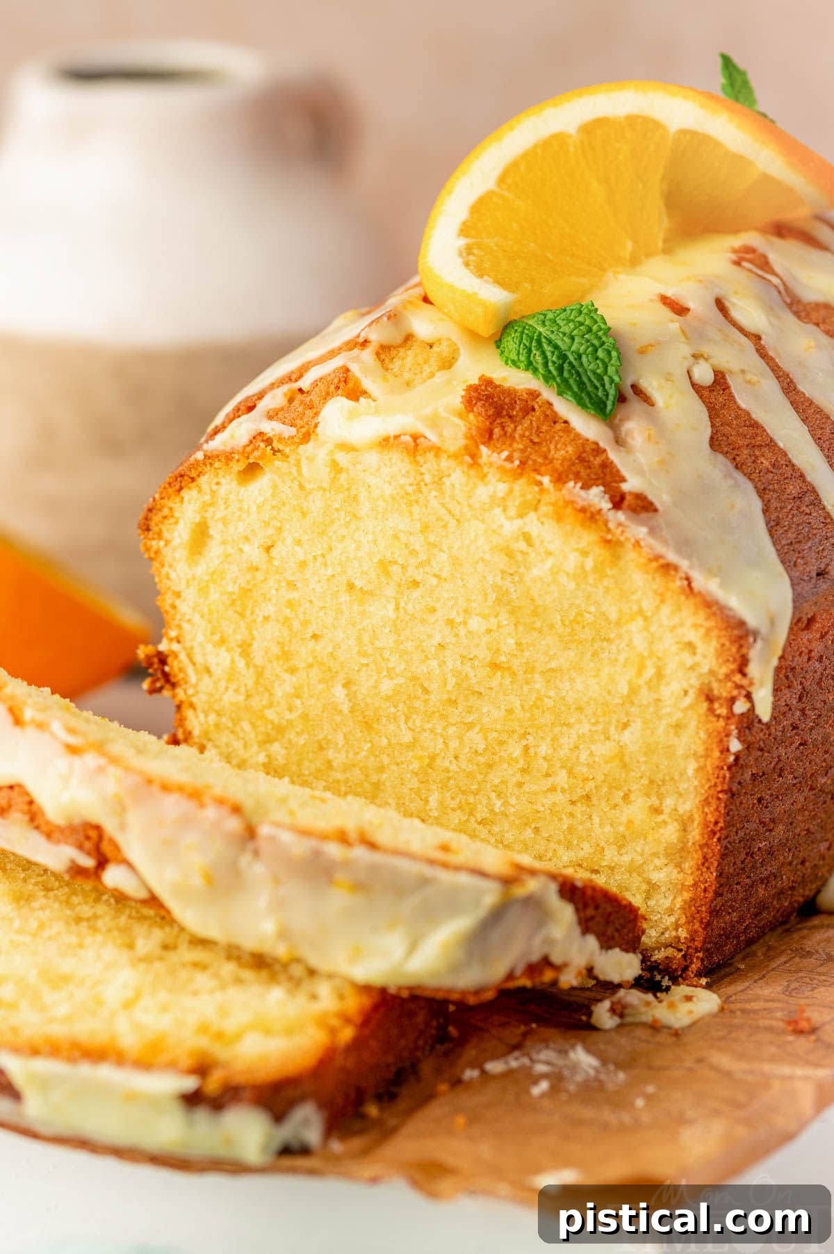 Zesty Orange Pound Cake 8 Angled shot of orange pound cake on cutting board with two slices cut off.