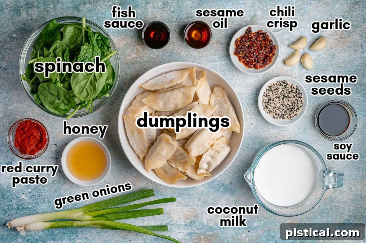 Crispy Sheet Pan Dumplings 5 An organized overhead shot displaying all the measured ingredients for baked dumplings, neatly arranged in small bowls and ready for preparation. Includes frozen dumplings, coconut milk, curry paste, and fresh spinach.