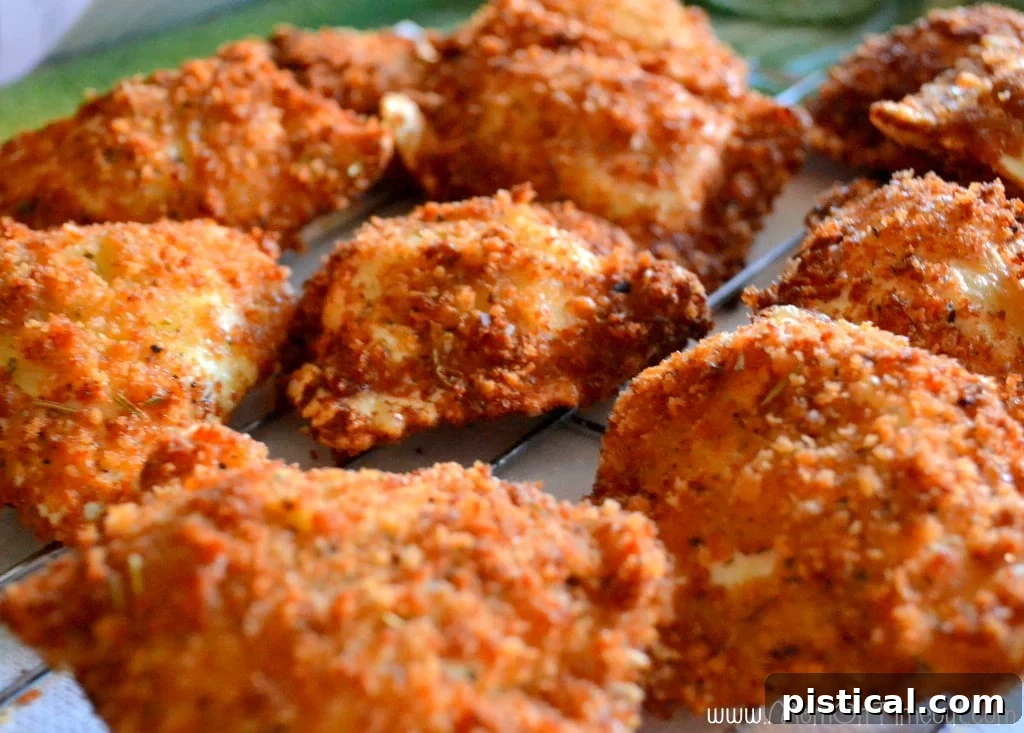 Platter of golden brown fried raviolis, garnished and ready to serve.