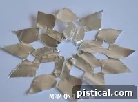 DIY Shiny Foil Snowflakes 12 Example pattern of cuts made on the folded foil and paper, demonstrating how they will form the snowflake design