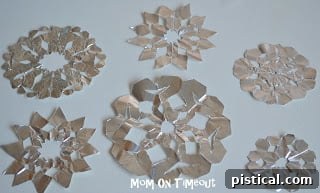 DIY Shiny Foil Snowflakes 14 A collection of beautifully crafted aluminum foil snowflakes, showcasing various intricate designs and patterns