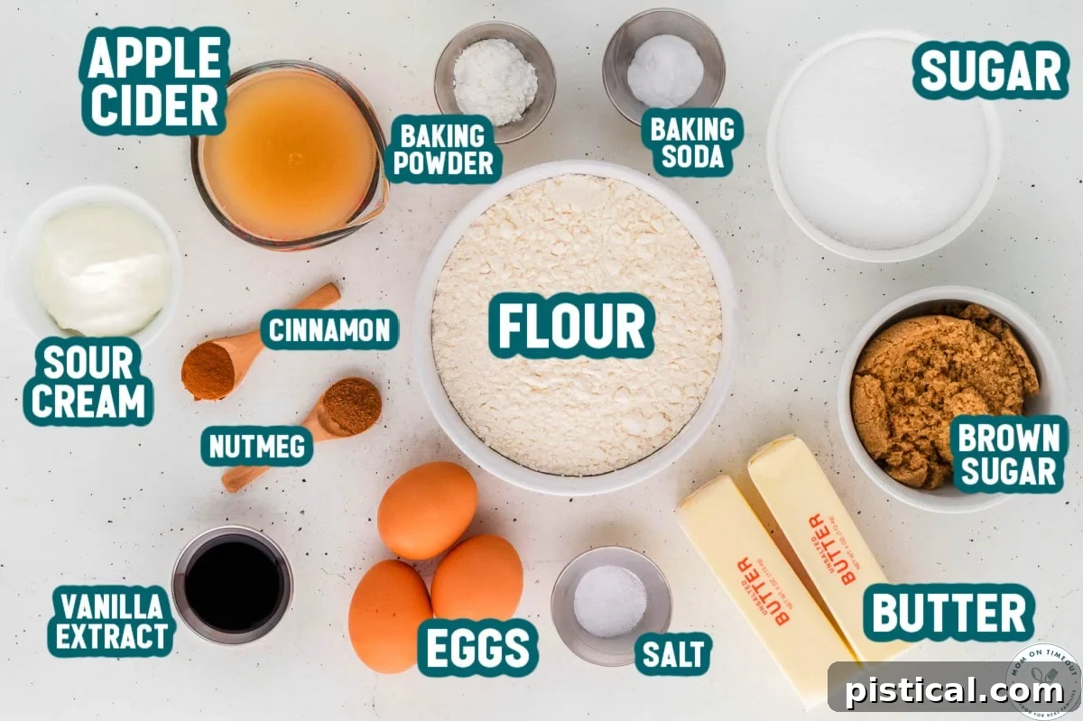 An inviting overhead shot showcasing all the precisely measured ingredients for the Apple Cider Donut Cake, neatly arranged in small bowls and clearly labeled, ready for baking.