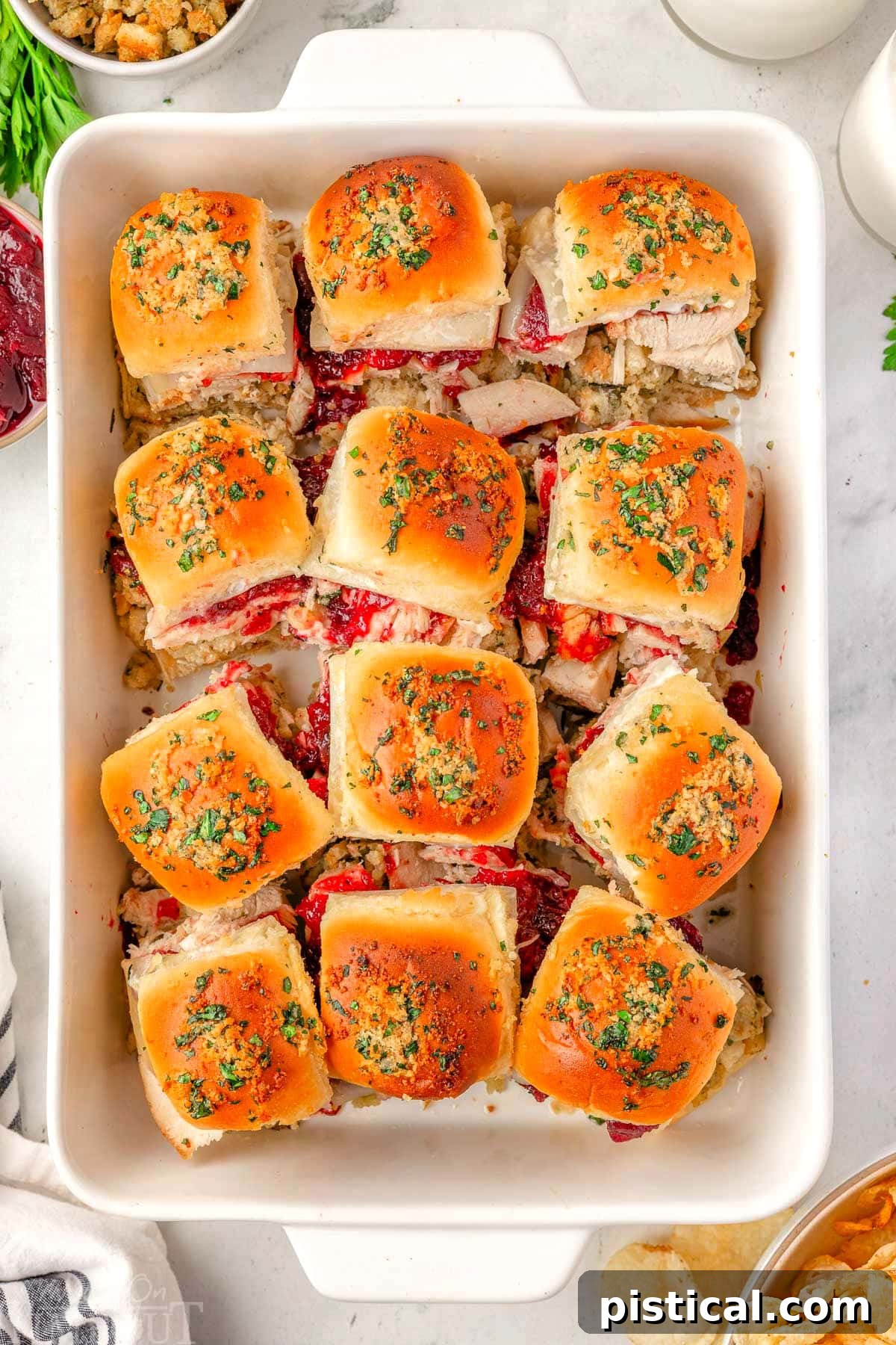 An overhead shot showcasing a full baking dish of 12 perfectly golden Turkey Sliders, ready to be served and enjoyed by a hungry crowd.