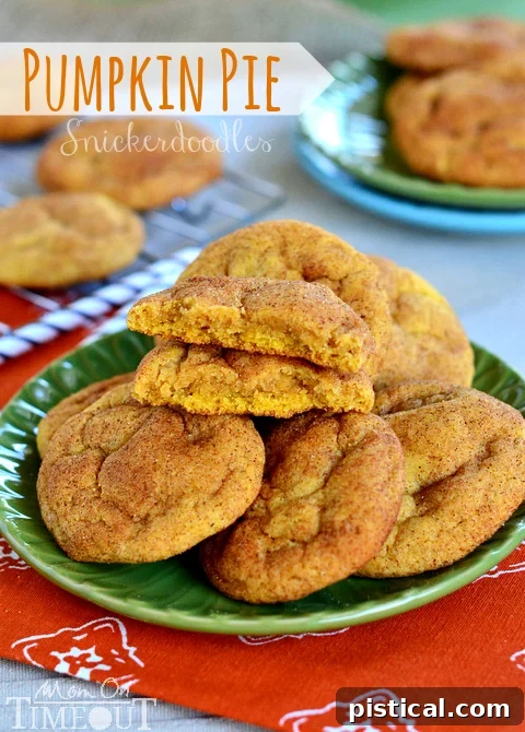 Delicious pumpkin pie snickerdoodles on a plate, with one cookie cut in half to show its soft, chewy interior. A perfect autumn treat.