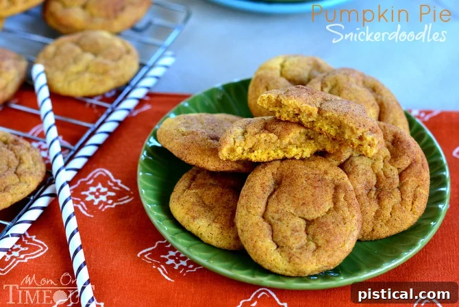 A close-up of a plate of freshly baked pumpkin pie snickerdoodles, highlighting their crackled cinnamon-sugar coating and inviting texture, ready to be enjoyed.