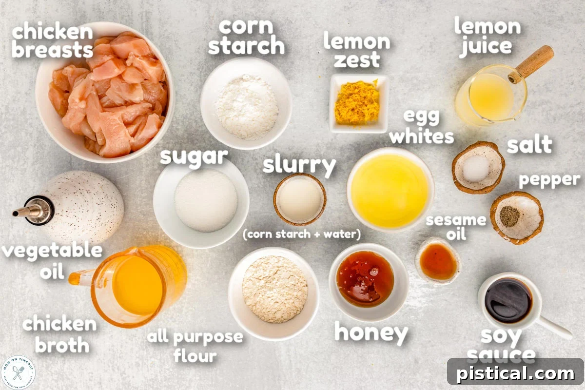 Overhead shot of chinese lemon chicken ingredients measured out into small bowls ready to be used in the recipe. Ingredients have a text overlay. Organized ingredients for Chinese Lemon Chicken, including fresh lemons, chicken breast, and various sauce components.