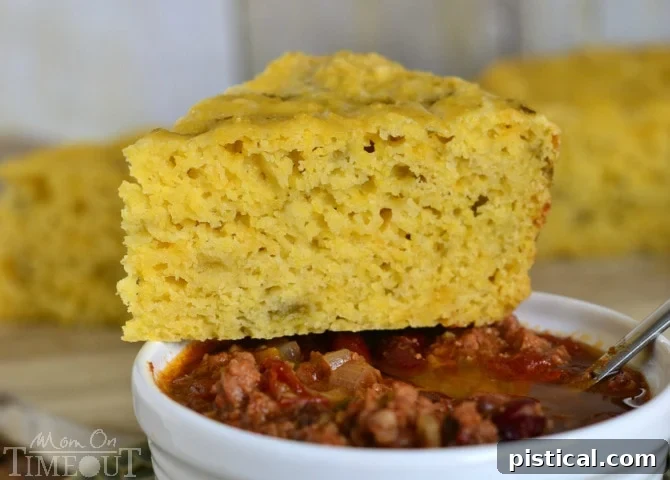 Close-up of fluffy and cheesy Slow Cooker Mexican Cornbread, showing the perfect texture and melted cheese. | MomOnTimeout.com