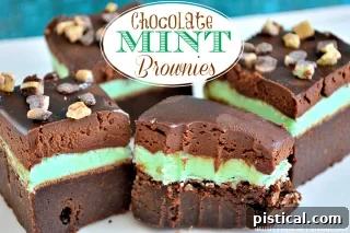 Rich Chocolate Mint Brownies with a green mint frosting and chocolate drizzle