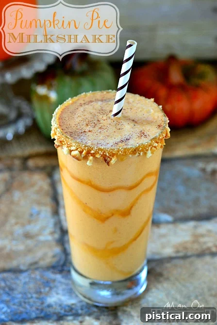 Delicious Pumpkin Pie Milkshake topped with whipped cream, caramel drizzle, and a sprinkle of pumpkin spice, ready for fall enjoyment.