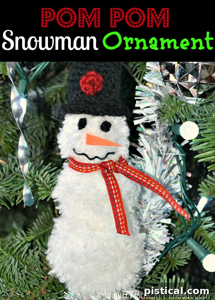 Adorable Pom Pom Snowman Ornament hanging on a Christmas tree branch