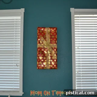Close-up of a picture frame wrapped in elegant silver Christmas paper