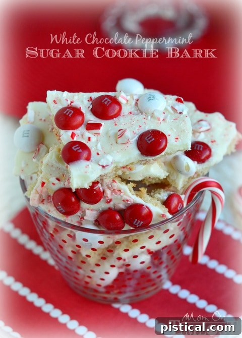 Pieces of White Chocolate Peppermint Sugar Cookie Bark on a festive plate, ready to be served