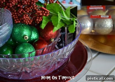 Assortment of colorful plastic bowls, plates, and shatterproof Christmas ornaments from a dollar store for DIY decor