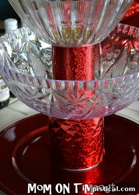 A two-tiered stand made from wrapped cans and plastic plates, assembled and ready for ornaments