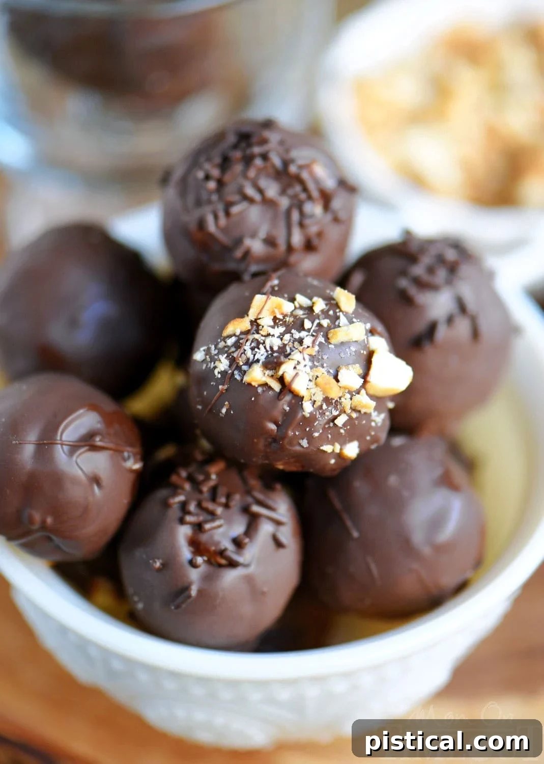 Peanut Butter Chocolate Crunch Bites 3 A pristine white glass bowl showcases a generous collection of whole chocolate peanut butter balls, each one perfectly coated and glistening, promising a delicious experience.