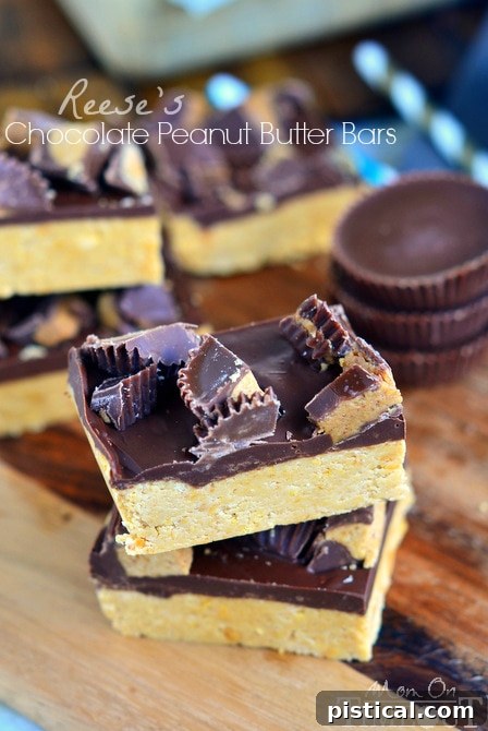 Stacked squares of Reese's Chocolate Peanut Butter Bars, showcasing the layers.