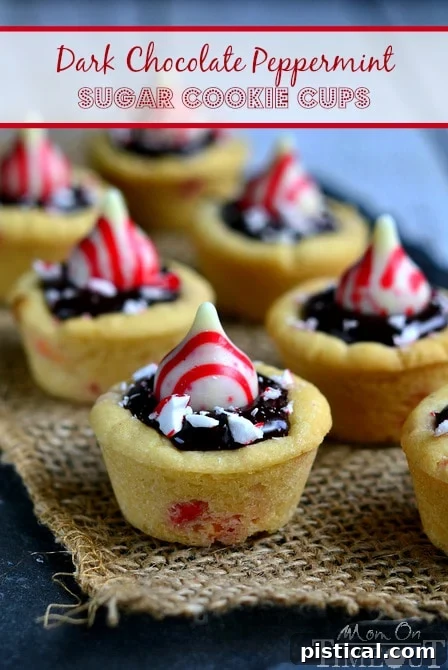 Dark Chocolate Peppermint Sugar Cookie Cups filled with chocolate ganache and topped with Candy Cane Hershey's Kisses. | MomOnTimeout.com #christmas #recipe A festive holiday platter brimming with Dark Chocolate Peppermint Sugar Cookie Cups, adorned with chocolate ganache and Candy Cane Hershey's Kisses.