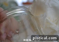 Nail polish remover being used to clean a jar