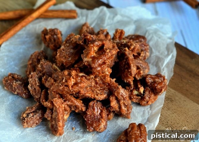 A wide shot of glistening Sugar and Spice Pecans spread out, showcasing their golden-brown coating and inviting texture.