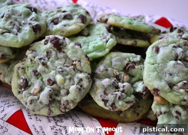 A large stack of Mint Chocolate Chip Cookies on a white plate