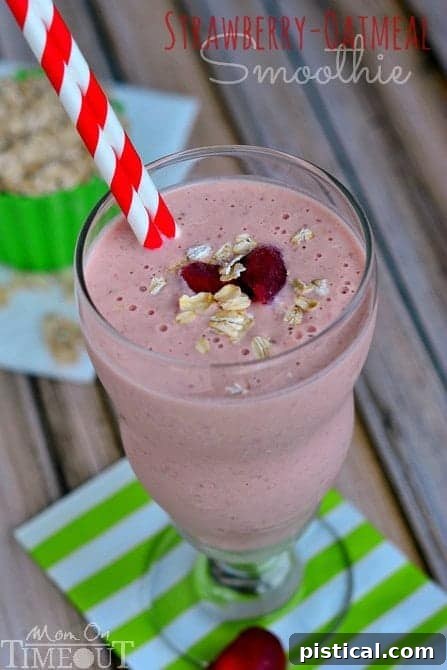 Another perspective of the Strawberry Oatmeal Smoothie, showcasing its vibrant color and tempting texture, garnished with fresh strawberries.