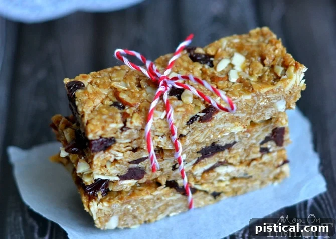 Close-up of the chewy texture of homemade no-bake granola bars, featuring visible oats, almonds, and dried cherries.