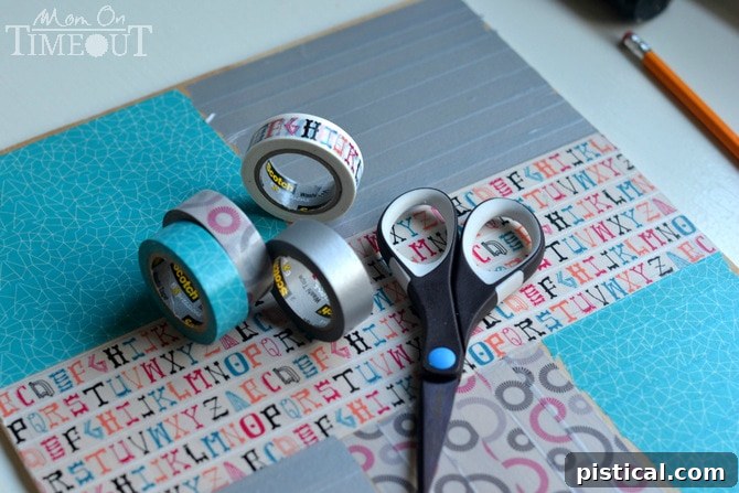 Hands applying colorful Washi tape to the sections of a plywood base, guided by pencil lines.
