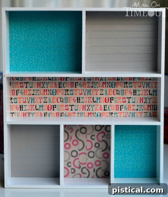 Assembled painted wooden dividers positioned on the Washi-taped plywood base, ready for final attachment.