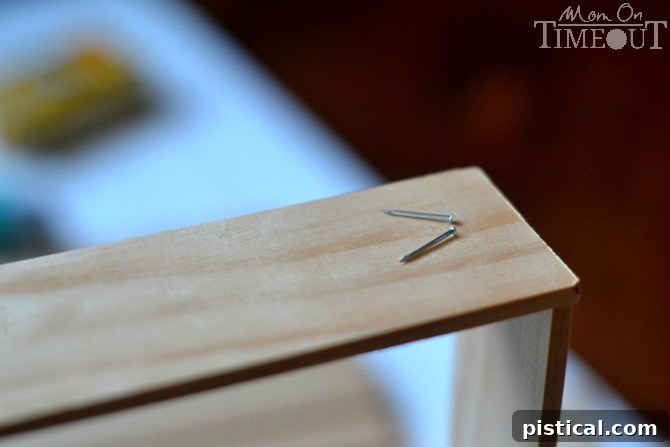 Wooden lattice dividers being nailed together to form compartments for the drawer organizer.