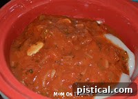 Two boneless, skinless chicken breasts and a jar of salsa, ready for slow cooking.