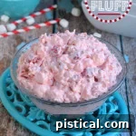 Cherry Fluff dessert salad in a small bowl, garnished with a single cherry.