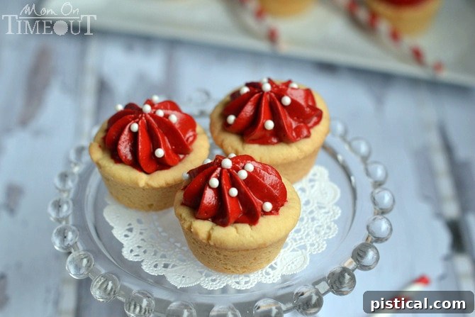 Easy Red Velvet Cheesecake Cookie Cups Recipe - MomOnTimeout.com A festive platter of Red Velvet Cheesecake Cookie Cups, adorned with sprinkles, perfect for a Valentine's Day gathering.