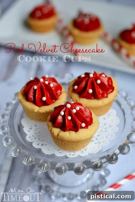 Homemade Red Velvet Cheesecake Cookie Cups - Simple Dessert Idea | MomOnTimeout.com Close-up of a single Red Velvet Cheesecake Cookie Cup, showcasing its creamy red velvet filling and a hint of the sugar cookie base, ready to be enjoyed.