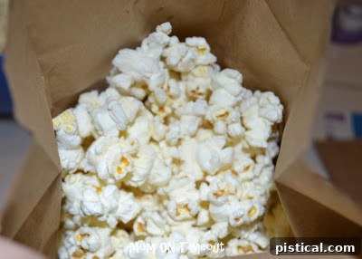 Unpopped popcorn kernels placed inside a brown paper bag, ready for microwave