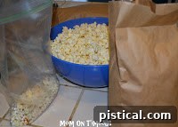 Crunchy Caramel Corn with Autumn Leaf Tags 15 Popcorn kernels poured into a paper bag, with the top folded and secured with tape